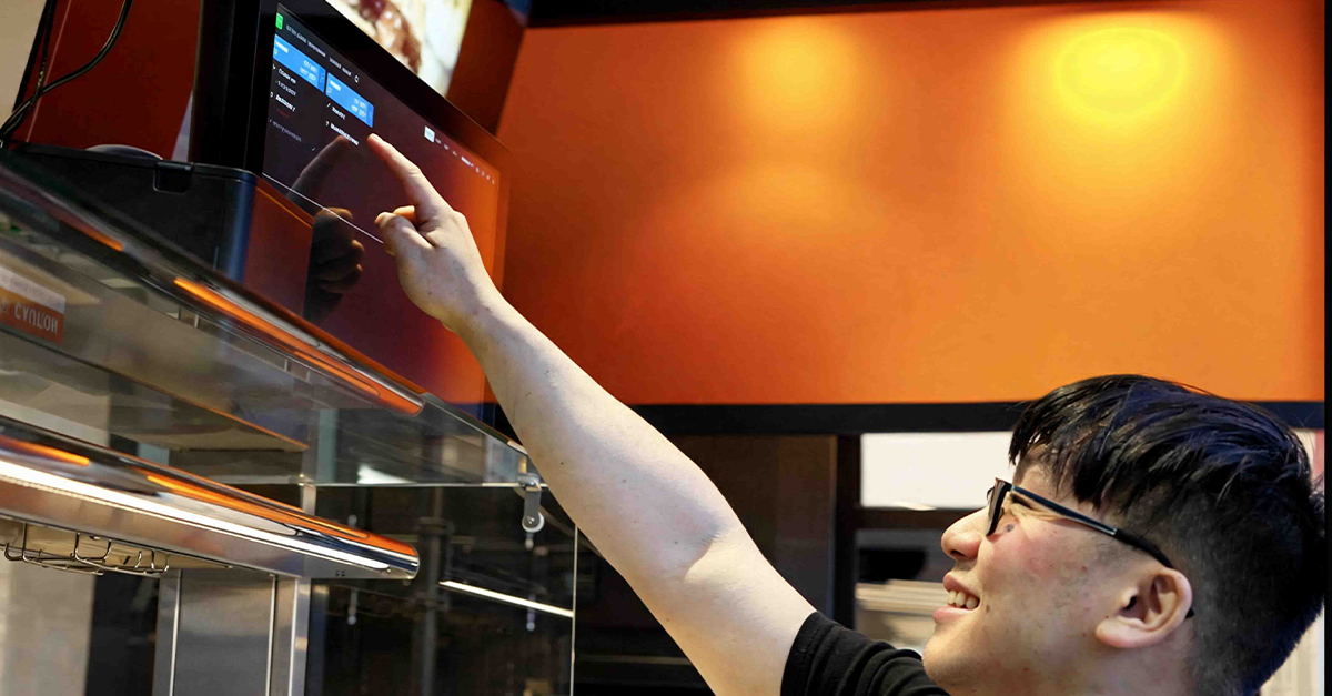 Staff member using Oolio Kitchen management screen